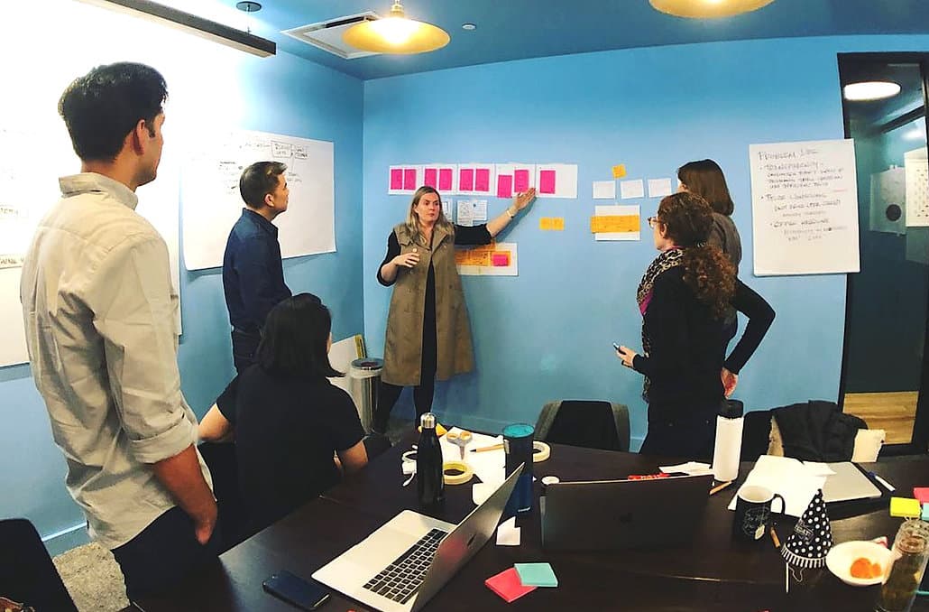 Design sprint session — stakeholders collaborating around greeting card concepts